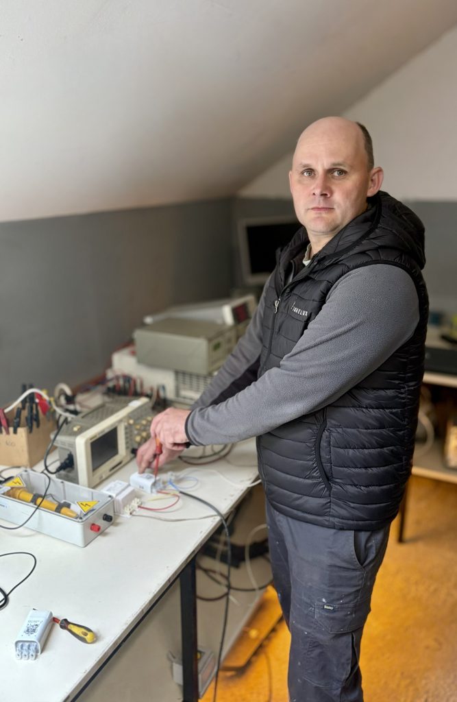 The Ignelux R&D and maintenance leader analyzing technical documentation and testing lighting components in the engineering laboratory.